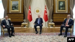 This handout photograph taken and released by the Turkish Presidency Press Office on July 26, 2023, shows Turkish President Recep Tayyip Erdogan (C) meeting with Chinese Foreign Minister, Wang Yi (L) and Turkish Foreign minister Hakan Fidan (R) at the Pre